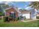 A charming brick-and-vinyl home with a well-maintained lawn and mature landscaping at 10080 Highland Creek Cir, Indian Land, SC 29707