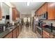 Stylish kitchen featuring dark countertops, stainless steel appliances, and a view into dining area at 10080 Highland Creek Cir, Indian Land, SC 29707