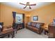 Relaxing living room shows hardwood desk, leather sofa and colorful painting and curtains at 10080 Highland Creek Cir, Indian Land, SC 29707