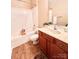 Bright bathroom featuring a bathtub, shower, and wood-look flooring at 11264 Hyde Pointe Ct, Charlotte, NC 28262
