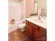 Bright bathroom featuring a bathtub, shower, and wood-look flooring at 11264 Hyde Pointe Ct, Charlotte, NC 28262