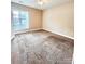 Carpeted bedroom with window, neutral walls, and standard electrical outlets at 11264 Hyde Pointe Ct, Charlotte, NC 28262