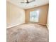 A cozy bedroom with neutral walls, carpet, and a ceiling fan at 11264 Hyde Pointe Ct, Charlotte, NC 28262
