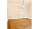 An empty dining room with wood floors, neutral walls, and a classic light fixture at 11264 Hyde Pointe Ct, Charlotte, NC 28262