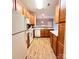 Well-lit kitchen with wood cabinets, white appliances, and a tiled backsplash at 11264 Hyde Pointe Ct, Charlotte, NC 28262
