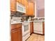 Well-equipped kitchen boasts wood cabinets, modern appliances, and mosaic backsplash at 11264 Hyde Pointe Ct, Charlotte, NC 28262