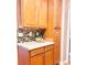 Kitchen with wood cabinets, mosaic backsplash, and ample storage space at 11264 Hyde Pointe Ct, Charlotte, NC 28262