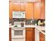Well-equipped kitchen boasts wood cabinets, modern appliances, and tile backsplash at 11264 Hyde Pointe Ct, Charlotte, NC 28262