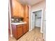 Kitchen with wood cabinets, mosaic backsplash, and a door to a storage area at 11264 Hyde Pointe Ct, Charlotte, NC 28262