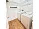 Convenient laundry room includes washer, dryer, and wire shelving at 11264 Hyde Pointe Ct, Charlotte, NC 28262