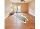 Bright living room features wood floors, a ceiling fan, and a door leading to the outside at 11264 Hyde Pointe Ct, Charlotte, NC 28262