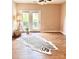Bright living room features wood floors, a ceiling fan, and a door leading to the outside at 11264 Hyde Pointe Ct, Charlotte, NC 28262