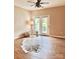 Bright living room with wood floors, ceiling fan, and double doors leading to a balcony at 11264 Hyde Pointe Ct, Charlotte, NC 28262