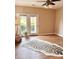 Bright living room features wood floors, a ceiling fan, and a door leading to the outside at 11264 Hyde Pointe Ct, Charlotte, NC 28262