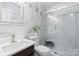 This modern bathroom offers gorgeous marble tiling and a glass enclosed shower at 6909 Green Haven Ln, Monroe, NC 28110