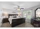 This spacious bedroom includes a ceiling fan, large window, and tasteful decor at 6909 Green Haven Ln, Monroe, NC 28110