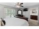Bright bedroom boasts a large window and adjacent full bathroom at 6909 Green Haven Ln, Monroe, NC 28110