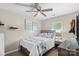 Cozy bedroom features a ceiling fan and a sun-filled window at 6909 Green Haven Ln, Monroe, NC 28110