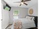 Serene bedroom featuring a ceiling fan, neutral decor, and a view to the front lawn at 6909 Green Haven Ln, Monroe, NC 28110