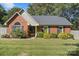Charming brick home featuring a manicured front yard and beautiful landscaping at 6909 Green Haven Ln, Monroe, NC 28110