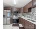 Well-lit kitchen featuring stainless steel appliances, luxury countertops, and tile backsplash at 6909 Green Haven Ln, Monroe, NC 28110