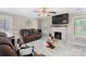 Cozy living room with a fireplace, tile flooring, and abundant natural light at 6909 Green Haven Ln, Monroe, NC 28110