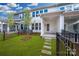Private backyard with a cozy patio area, stepping stones, and a manicured lawn surrounded by wrought iron fence at 10105 Mamillion Dr, Huntersville, NC 28078