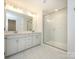 Large bathroom with double vanity and frameless shower at 10105 Mamillion Dr, Huntersville, NC 28078
