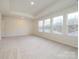 Spacious bedroom with carpeted floor and multiple windows at 10105 Mamillion Dr, Huntersville, NC 28078