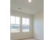 Well-lit bedroom featuring carpet and two large windows at 10105 Mamillion Dr, Huntersville, NC 28078