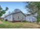 Exterior rear view of home featuring spacious yard and utility equipment at 3004 Ridge Ave, Charlotte, NC 28208