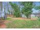Spacious backyard with a storage shed, mature trees, and a mix of grassy and mulched areas at 3004 Ridge Ave, Charlotte, NC 28208