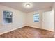 This bedroom features wood-look floors and two windows offering plenty of natural light at 3004 Ridge Ave, Charlotte, NC 28208