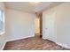 Bedroom featuring wood-look floors, two doors, and access to the attic at 3004 Ridge Ave, Charlotte, NC 28208