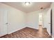 Bright bedroom with wood-look floors and an ensuite bathroom entrance at 3004 Ridge Ave, Charlotte, NC 28208