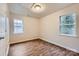 A bedroom featuring wood-look floors, two windows, and a closet door at 3004 Ridge Ave, Charlotte, NC 28208