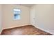 Bedroom featuring natural light, wood-look floors, and closet at 3004 Ridge Ave, Charlotte, NC 28208