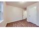 This bedroom has wood-look floors, two doors, and a neutral color palette at 3004 Ridge Ave, Charlotte, NC 28208