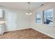 Dining area with a modern chandelier and two windows providing ample natural light at 3004 Ridge Ave, Charlotte, NC 28208