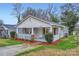 Charming home with a welcoming porch, stylish shutters, and landscaped front yard at 3004 Ridge Ave, Charlotte, NC 28208