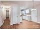 Open kitchen layout with white cabinets, light countertops, and a view into the dining area at 3004 Ridge Ave, Charlotte, NC 28208