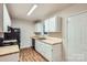 Clean kitchen with white cabinets, light countertops, modern appliances, and wood-look flooring at 3004 Ridge Ave, Charlotte, NC 28208