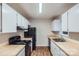 Functional kitchen with white cabinets, wooden countertops, and modern black appliances at 3004 Ridge Ave, Charlotte, NC 28208