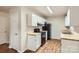 Bright kitchen featuring white cabinetry, black appliances, and wood-look flooring for a modern appeal at 3004 Ridge Ave, Charlotte, NC 28208