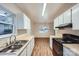 Efficient kitchen featuring light wood countertops, white cabinets, and updated black appliances at 3004 Ridge Ave, Charlotte, NC 28208