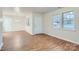 Spacious living room with wood-look flooring and a front door leading to the outside at 3004 Ridge Ave, Charlotte, NC 28208