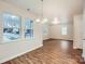 Open-concept living and dining area with wood-look floors and natural light at 3004 Ridge Ave, Charlotte, NC 28208