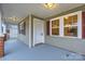 Covered front porch featuring neutral siding, contrasting shutters, and a secure front entry door at 3004 Ridge Ave, Charlotte, NC 28208