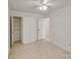 Bright bedroom with a ceiling fan, closet, and door leading to another room at 563 Goldstaff Ln, Charlotte, NC 28273
