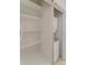 A linen closet with shelving with an adjacent washer and dryer combo at 563 Goldstaff Ln, Charlotte, NC 28273